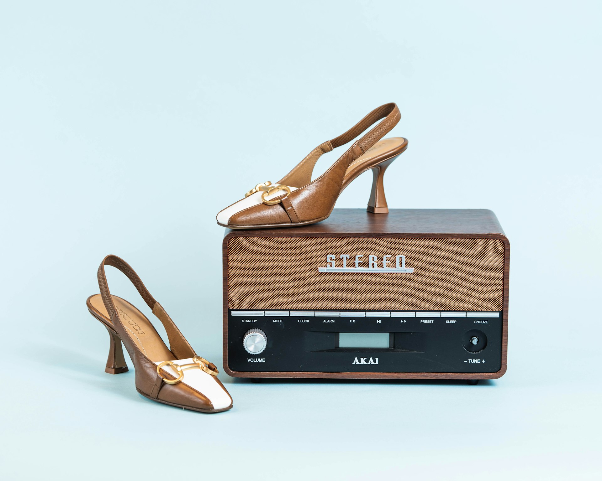 a pair of shoes sitting on top of a radio